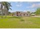 Charming single-story home with a well-manicured lawn and mature trees at 611 Robinson Oaks Ln, Plant City, FL 33567