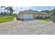 Attached two-car garage with a wide concrete driveway and manicured landscaping at 611 Robinson Oaks Ln, Plant City, FL 33567