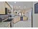 Open kitchen with stainless steel appliances, granite counters, tile backsplash, and ample cabinet space at 611 Robinson Oaks Ln, Plant City, FL 33567