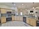 Well-equipped kitchen with stainless steel appliances, granite countertops, and ample storage space, ready for cooking at 611 Robinson Oaks Ln, Plant City, FL 33567