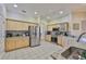Bright eat-in kitchen features stainless appliances, tile floors and light wood cabinets at 611 Robinson Oaks Ln, Plant City, FL 33567