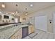Spacious kitchen with a breakfast bar, stainless steel dishwasher, and plenty of counter and cabinet space at 611 Robinson Oaks Ln, Plant City, FL 33567