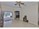 Open living area with tile floor, ceiling fan and view of the screened patio at 611 Robinson Oaks Ln, Plant City, FL 33567