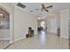 Open-concept living area with tile floors and a view into the dining area, perfect for entertaining guests at 611 Robinson Oaks Ln, Plant City, FL 33567