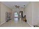 Living room with tiled floors and ceiling fan, leading to a screened patio at 611 Robinson Oaks Ln, Plant City, FL 33567