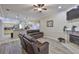 Open-concept living area with kitchen view, a leather sofa and fireplace at 611 Robinson Oaks Ln, Plant City, FL 33567