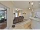 Open-concept living area with kitchen access, a leather sofa and patio view at 611 Robinson Oaks Ln, Plant City, FL 33567