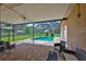 Screened patio area with outdoor seating and view of the pool and barn at 611 Robinson Oaks Ln, Plant City, FL 33567
