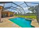 A screened-in pool and patio with expansive lawn at 611 Robinson Oaks Ln, Plant City, FL 33567