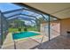 A screened-in pool, a patio area, and a spacious lawn in the backyard at 611 Robinson Oaks Ln, Plant City, FL 33567