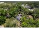 Aerial view showcasing the property surrounded by lush greenery and trees at 6489 30Th N St, St Petersburg, FL 33702