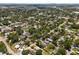 An aerial shot shows residential homes surrounded by lush greenery in a peaceful suburban setting, near the city skyline at 6489 30Th N St, St Petersburg, FL 33702