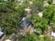 Aerial view shows the house and the wooded property at 6489 30Th N St, St Petersburg, FL 33702