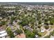 An aerial perspective reveals a quiet neighborhood with mature trees, offering a serene residential setting at 6489 30Th N St, St Petersburg, FL 33702