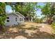 View of backyard featuring trees, grass and small outbuildings behind the house at 6489 30Th N St, St Petersburg, FL 33702
