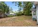 View of backyard featuring trees, grass and outbuildings behind the house at 6489 30Th N St, St Petersburg, FL 33702