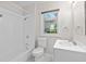 Bathroom with tub and shower combination features white tiling at 6489 30Th N St, St Petersburg, FL 33702