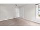 Cozy bedroom featuring neutral paint, plush carpet, and bright natural lighting at 6489 30Th N St, St Petersburg, FL 33702