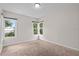 Bedroom with neutral paint and carpet features natural light from two large windows at 6489 30Th N St, St Petersburg, FL 33702