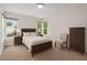 Bedroom featuring a bed, bedside tables, and a chest of drawers, with windows providing natural light at 6489 30Th N St, St Petersburg, FL 33702