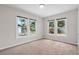 Cozy bedroom with neutral walls, carpet flooring, and three windows allowing ample natural light at 6489 30Th N St, St Petersburg, FL 33702