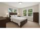 Well-lit bedroom with a large bed, bedside tables, and a chest of drawers offering storage at 6489 30Th N St, St Petersburg, FL 33702