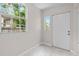 Light filled entryway featuring a white door and tile flooring at 6489 30Th N St, St Petersburg, FL 33702