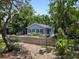 Charming home with blue siding, a picket fence, and lush landscaping at 6489 30Th N St, St Petersburg, FL 33702