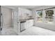 Modern kitchen with white cabinetry, stainless steel appliances, and a granite countertop at 6489 30Th N St, St Petersburg, FL 33702