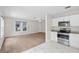 Open floor plan of the kitchen and living room featuring hard surface flooring and stainless appliances at 6489 30Th N St, St Petersburg, FL 33702