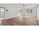 Spacious living room with wood-look flooring, neutral walls, and natural light from several windows at 6489 30Th N St, St Petersburg, FL 33702