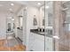 Stylish bathroom with granite counters, white cabinets, wood floors, and glass enclosed shower at 6611 Surfside Blvd, Apollo Beach, FL 33572