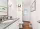Bright bathroom with granite countertop, modern fixtures, and wood-look floors at 6611 Surfside Blvd, Apollo Beach, FL 33572