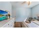 Serene bedroom with light blue walls, wood floors, and bright lighting at 6611 Surfside Blvd, Apollo Beach, FL 33572