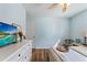 Serene bedroom with light blue walls, wood floors, and bright lighting at 6611 Surfside Blvd, Apollo Beach, FL 33572