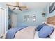 Comfortable bedroom with blue walls, ceiling fan, and decorative wall art at 6611 Surfside Blvd, Apollo Beach, FL 33572