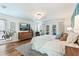 Bright bedroom featuring a bed, dresser, and access to a patio at 6611 Surfside Blvd, Apollo Beach, FL 33572