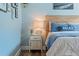 Bedroom featuring a light blue wall with beach-themed decor and a wooden bed frame at 6611 Surfside Blvd, Apollo Beach, FL 33572