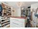 Spacious walk-in closet with custom shelving and an elegant chandelier at 6611 Surfside Blvd, Apollo Beach, FL 33572