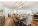 Bright dining room featuring a wood table with six upholstered chairs, and wood floors at 6611 Surfside Blvd, Apollo Beach, FL 33572