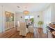 Bright dining area with wooden floors, elegant lighting, and view from glass doors at 6611 Surfside Blvd, Apollo Beach, FL 33572