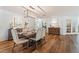 Elegant dining room featuring wood floors, stylish lighting, and comfortable seating, perfect for entertaining guests at 6611 Surfside Blvd, Apollo Beach, FL 33572