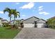 Charming single-story home with well-maintained landscaping, and a spacious driveway leading to a two-car garage at 6611 Surfside Blvd, Apollo Beach, FL 33572