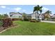 Beautiful home with palm trees and a well-manicured lawn at 6611 Surfside Blvd, Apollo Beach, FL 33572