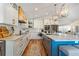 Bright kitchen with white cabinets, stainless steel appliances, marble countertops, and wood floors at 6611 Surfside Blvd, Apollo Beach, FL 33572