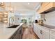 Modern kitchen featuring granite countertops, stainless steel appliances, and an adjacent dining area at 6611 Surfside Blvd, Apollo Beach, FL 33572