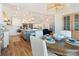Bright open kitchen featuring white cabinets, a large island, pendant lighting, and a adjacent dining area at 6611 Surfside Blvd, Apollo Beach, FL 33572