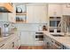 Bright kitchen featuring white cabinetry, stainless steel appliances, and stylish tile backsplash at 6611 Surfside Blvd, Apollo Beach, FL 33572