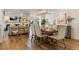 Open-concept living room featuring a dining area, fireplace, built-in shelves, and wood floors at 6611 Surfside Blvd, Apollo Beach, FL 33572