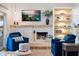 Bright living room featuring comfortable seating, a fireplace, and built-in shelves at 6611 Surfside Blvd, Apollo Beach, FL 33572